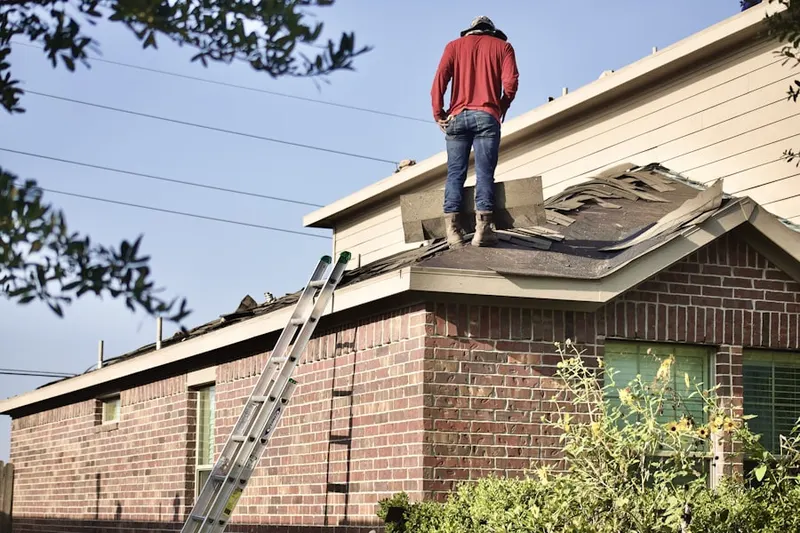 Professional roofer working on a residential roof in Marcellus Falls